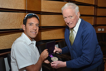 Olympian Leo Manzano and Dr. Denton Cooley hold Leo's silver medal Olympian Leo Manzano and Dr. Denton Cooley hold Leo's silver medal